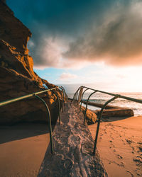 Scenic view of beach against sky during sunset