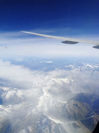 Aerial view of snowcapped mountains against sky