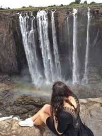 Woman looking at waterfall