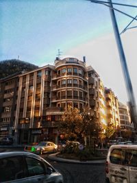 Cars on road in city against clear sky