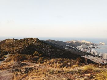 Scenic view of landscape and buildings against clear sky