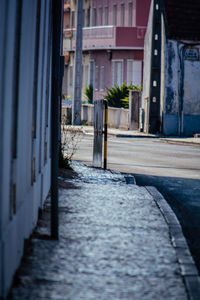 Empty alley amidst buildings in city