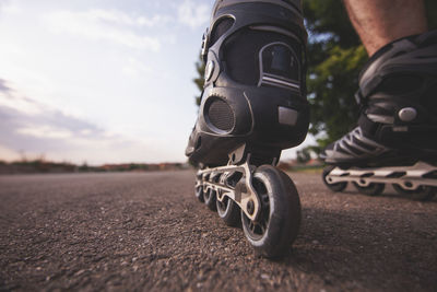 Low section of man roller skating on road