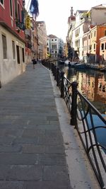 Footpath amidst buildings in city