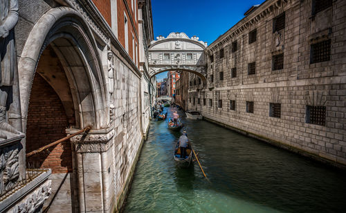 Bridge over canal amidst buildings