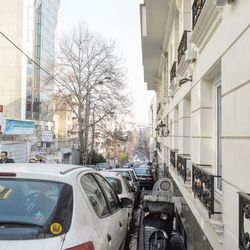 Cars on street amidst buildings in city