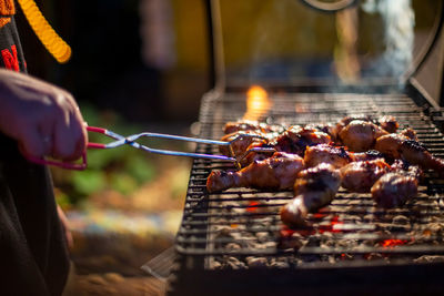 Close-up of preparing food on barbecue grill