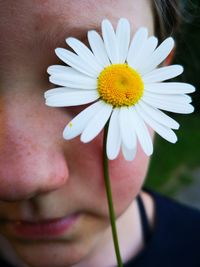 Close-up of girl holding white flower