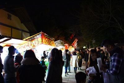 People in traditional clothing against sky at night