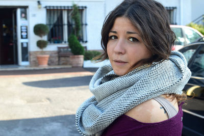 Portrait of beautiful woman standing in city