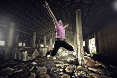 Young man jumping at home