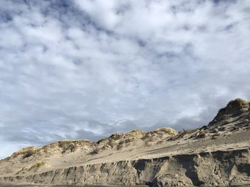 Low angle view of rock formations against sky