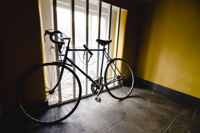 Bicycle against wall in building