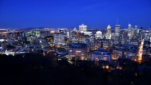 High angle view of buildings lit up at night