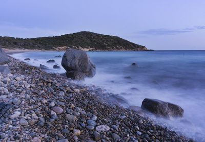 Rocks on beach against sky