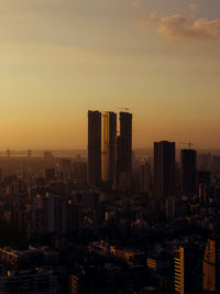 Cityscape against sky during sunset