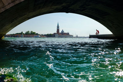 Church of san giorgio maggiore against sky seen through arch bridge