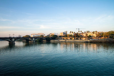 Bridge over river with buildings in background