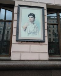 Portrait of woman seen through glass window of building