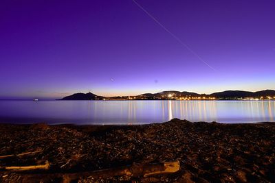 Scenic view of lake against clear sky at night