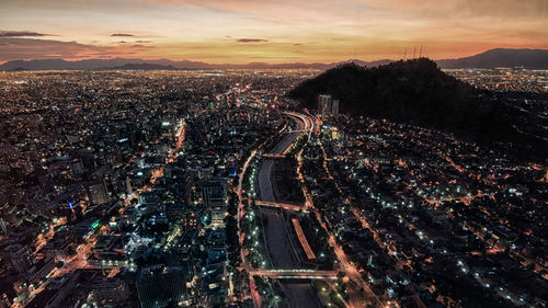High angle view of city lit up at night