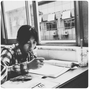 Woman sitting in front of window