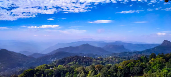 Scenic view of mountains against blue sky