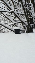 Snow covered metal grate on field