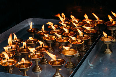 View of candles burning in illuminated building