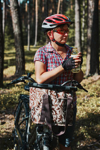 Man riding bicycle in forest