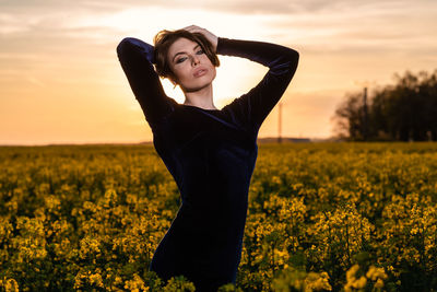 Beautiful young woman standing in field