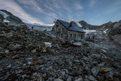 Scenic view of building and mountains against sky