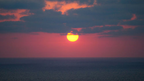 Scenic view of sea against romantic sky at sunset