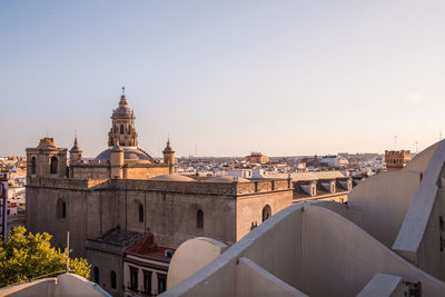 Buildings in city against clear sky