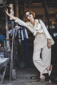 Portrait of young woman wearing sunglasses standing outdoors