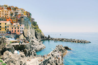 Panoramic view of sea and buildings against sky