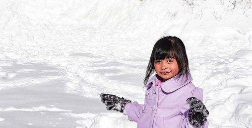 Portrait of a smiling girl in snow