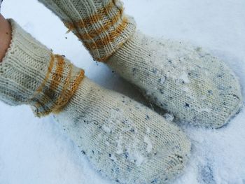 Low section of person wearing wool socks on snow