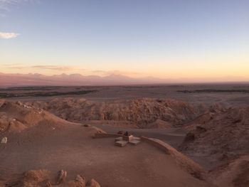 Scenic view of desert against sky during sunset