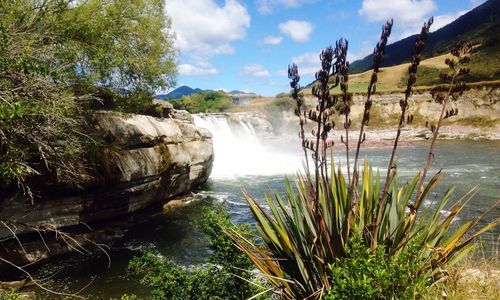 Waterfall and river against sky