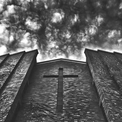 Low angle view of built structure against cloudy sky