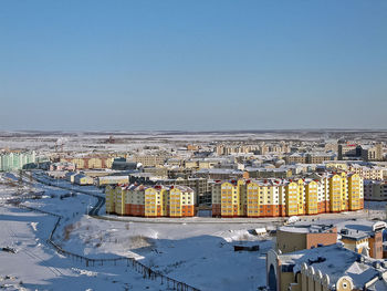 High angle view of buildings against clear sky during winter