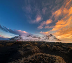 Scenic view of snowcapped mountains against sky during sunset