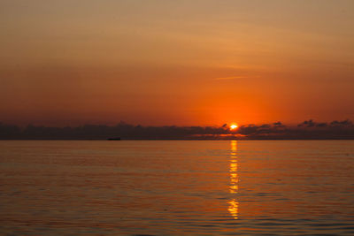 Scenic view of lake at sunset