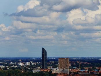 Cityscape against cloudy sky