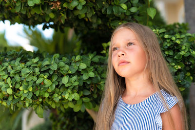 Portrait face of candid happy little kid girl of eight years old with long blond hair