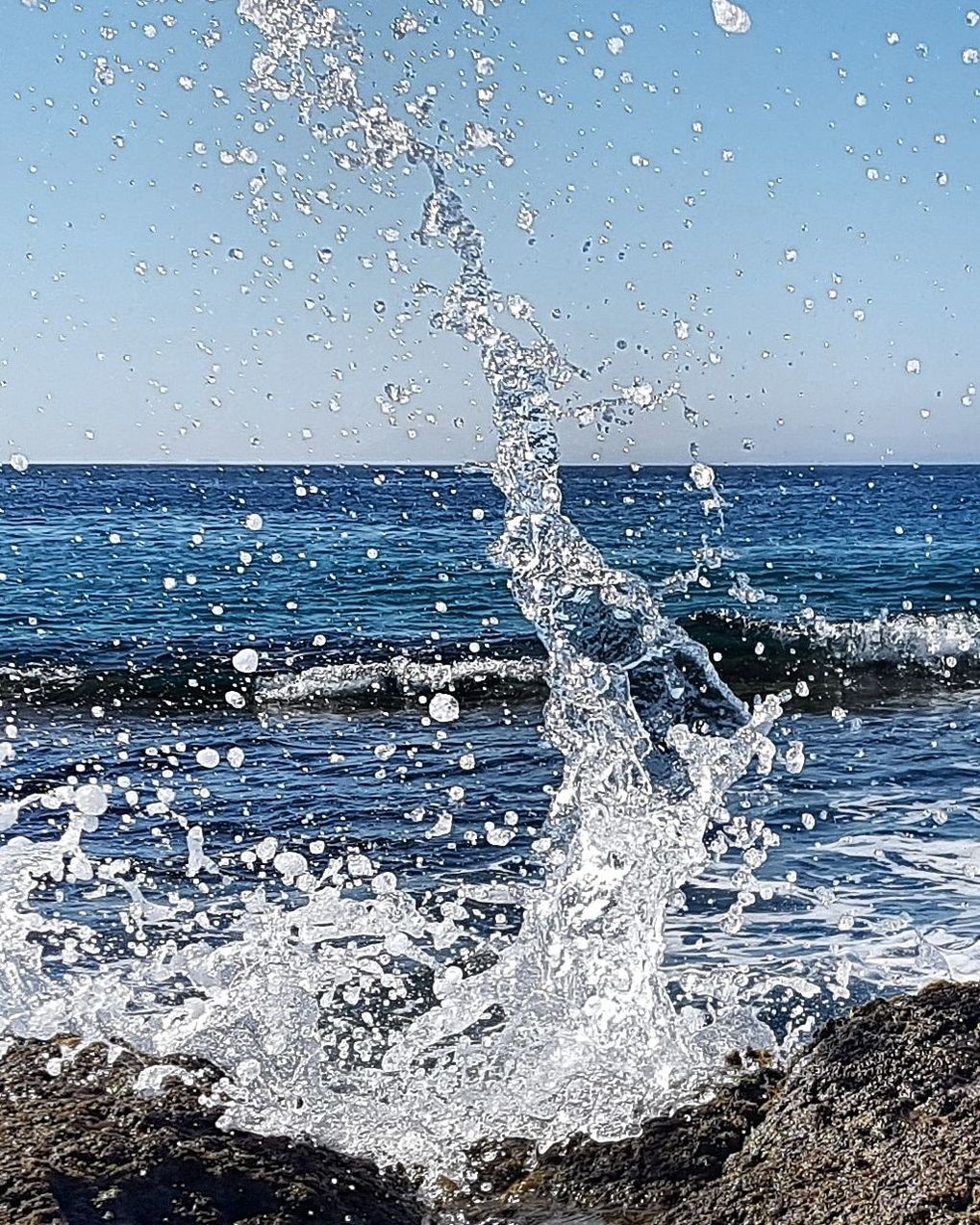 sea, water, motion, splashing, horizon, horizon over water, wave, sky, beauty in nature, land, nature, beach, scenics - nature, no people, day, blue, power in nature, sport, outdoors, breaking