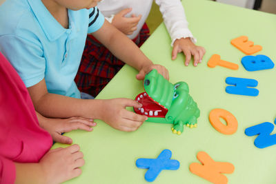 Midsection of child playing with toy blocks