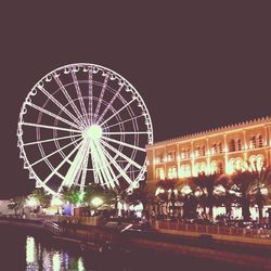 Low angle view of illuminated ferris wheel at night