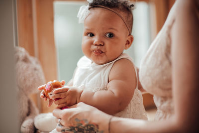 Cute baby girl sitting at home